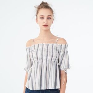 Off the shoulder shirt with straps.
